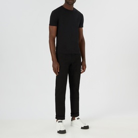 Model wearing Boss Black Casual Maine Mid Rise Straight Leg Jeans in black, styled with a black crew-neck tee and white trainers