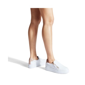 Model wearing Carvela Comfort Cash Slip On Trainers in white, leather upper, flatform white sole, no-lace design