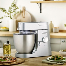 Kenwood Chef XL 6.7L 1200W Food Mixer in silver, styled in a kitchen setting with food and ingredients on the counter