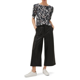Model wearing Phase Eight Bryony Print Top in multi abstract print with ruched sleeves, styled with black wide-leg culottes and white trainers