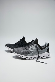 On Running Cloudswift Trainers in black and grey, knit upper, white CloudTec sole, two pairs displayed on grey background