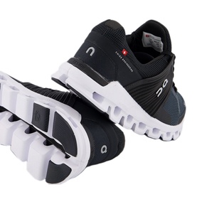 On Running Cloudswift Performance Trainers in black, showing top and sole views with white chunky outsole and mesh upper