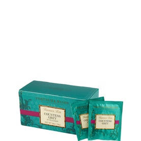Fortnum & Mason Countess Grey Teabags in teal box with gold detailing, shown alongside two individually wrapped teabags