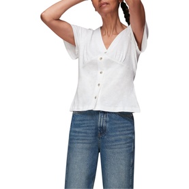 Model wearing Whistles Button Front Frill Top in white with short sleeves and V-neck, styled with blue wide-leg jeans