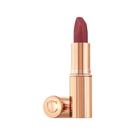 Charlotte Tilbury Matte Revolution Lipstick in a muted rose-brown shade, open bullet with gold rose-toned case