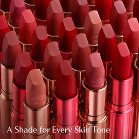 Charlotte Tilbury Matte Revolution Lipstick collection displayed in multiple red and nude shades with gold packaging, with text "A Shade for Every