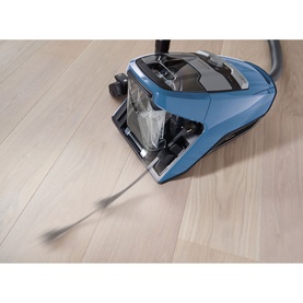 Miele CX1 Blizzard 800W Vacuum Cleaner in blue, bagless cylinder design on light wood flooring with flexible hose extended