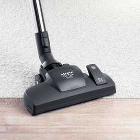 Miele CX1 Blizzard 800W Vacuum Cleaner blue floorhead attachment shown on carpet and hard floor surface