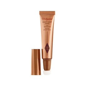 Charlotte Tilbury Hollywood Beauty Light Wand liquid highlighter in bronze-toned tube with rose gold cap, shown uncapped