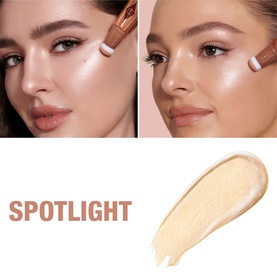 Charlotte Tilbury Hollywood Beauty Light Wand highlighter shown on two models' cheekbones beside a cream swatch labelled Spotlight