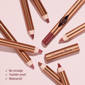 Charlotte Tilbury Lip Cheat lip liner pencils in assorted nude and berry shades with gold barrels, showing no-smudge, transfer-proof, waterproof
