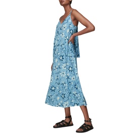Model wearing Whistles Cecilia Batik Garland Dress in blue floral print, styled with black leather sandals