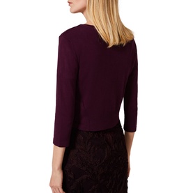 Model wearing Phase Eight Catie Cardigan in berry, three-quarter sleeves, cropped fit, shown from back, styled with floral skirt