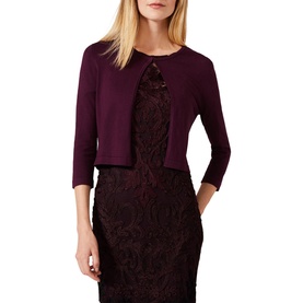 Model wearing Phase Eight Catie Cardigan in dark plum, cropped silhouette with three-quarter sleeves and open front, styled over a lace dress