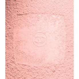 CHANEL Powder Blush in soft pink, loose powder texture with embossed CC logo visible on surface