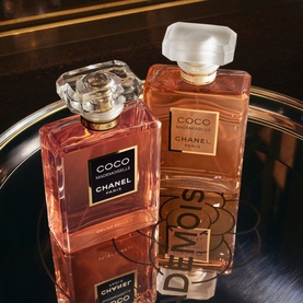 Chanel Coco Mademoiselle Eau de Parfum Spray, two amber glass bottles with frosted and crystal caps on a mirrored tray