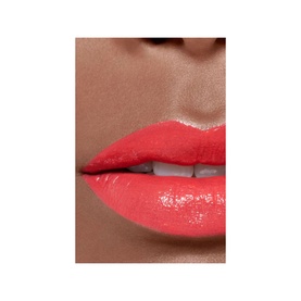 CHANEL Ultrawear Shine Liquid Lip Colour worn on lips, shown in a coral-red glossy finish on a close-up model shot