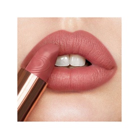 Charlotte Tilbury Matte Revolution Refill lipstick in Wedding Belles, a muted pink-mauve, shown applied on model's lips with rose gold bullet visible