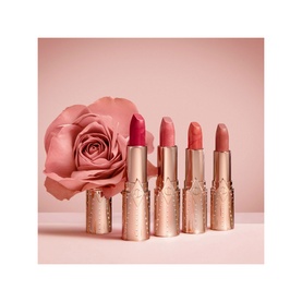Charlotte Tilbury Matte Revolution Refill lipsticks in Wedding Belles shades, five rose-gold bullets displayed with a pink rose backdrop