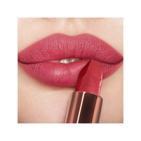 Charlotte Tilbury Matte Revolution Refill lipstick in First Dance, a warm rosy pink, shown applied on model's lips with bullet visible below