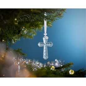 Waterford Christmas Cross Ornament in clear crystal with engraved detailing, hanging from a Christmas tree with ribbon