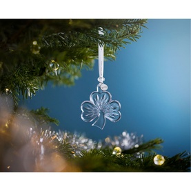 Waterford Christmas Shamrock Ornament in clear crystal, hanging from a decorated Christmas tree with ribbon