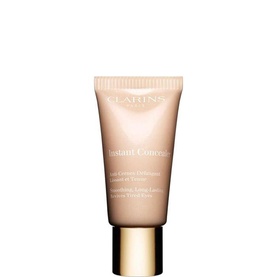 Clarins Instant Concealer in a nude-toned tube with gold cap, compact size for targeted coverage