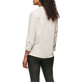 Model wearing Whistles Classic Silk Shirt in white, rear view, with dark slim-leg trousers. Relaxed fit with gathered cuffs