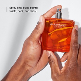 Clinique Happy For Men Cologne Spray 100ml held in hands, with text overlay showing pulse point application instructions