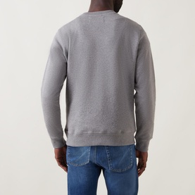 Model wearing Calvin Klein Jeans Monogram Logo Sweat Top in grey, back view, styled with blue denim jeans