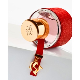 Carolina Herrera CH Woman Eau de Toilette with red leather-wrapped bottle, gold CH logo cap and dangling gold CH charm pendant
