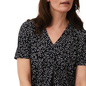 Model wearing Phase Eight Cara Ditsy Floral Top in blue with white ditsy floral print, V-neck and short sleeves, close-up view