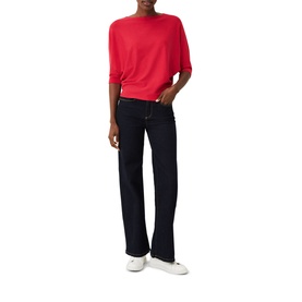 Model wearing Phase Eight Cristine Batwing Knit Sweater in pink, styled with dark indigo wide-leg jeans and white trainers