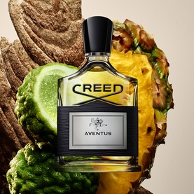 Creed Aventus Eau de Parfum black and gold bottle styled with pineapple, lime and wood ingredients