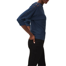 Model wearing Phase Eight Cristine Slash Knit in blue with slash detail at shoulders, styled with black trousers