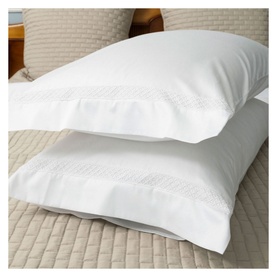 Piubelle Diamantine Housewife Pillowcase Pair in cream with subtle woven diamond border detail, styled on a made bed