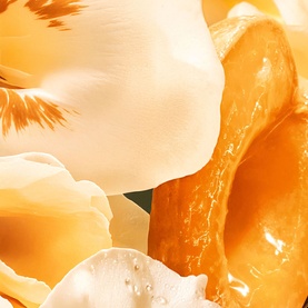 Dior J'adore Shimmering Hair Mist golden floral petals lifestyle detail, evoking the fragrance's luminous floral scent