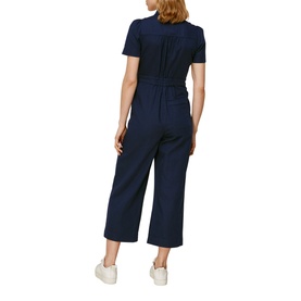 Model wearing Whistles Emma Pocket Detail Jumpsuit in blue, short-sleeve, wide-leg cropped style, shown from the back with white trainers