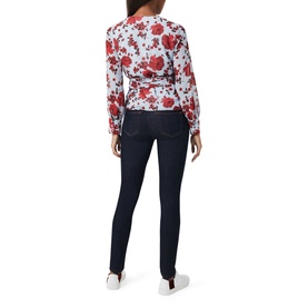 Model wearing Hobbs Elizabeth Blouse in multi red floral print with long sleeves, styled with dark navy skinny jeans and white trainers, back view