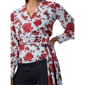 Model wearing Hobbs Elizabeth Blouse in multi floral print, wrap-front style with long sleeves and tie waist, styled with dark jeans