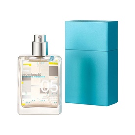 Escentric Molecules Escentric 05 Eau de Toilette, clear rectangular spray bottle with geometric label beside turquoise travel case