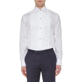 Model wearing Eton Bib Front Evening Shirt in white with navy trousers, featuring black stud buttons and pleated bib front panel