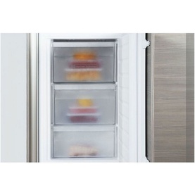 Whirlpool 70-30 Integrated Fridge Freezer freezer compartment showing three pull-out drawers filled with food items