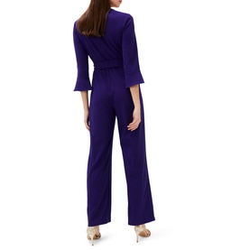 Model wearing Phase Eight Eydie Fluted Sleeve Jumpsuit in blue, rear view showing fluted 3/4 sleeves, wide-leg trousers and belt tie detail