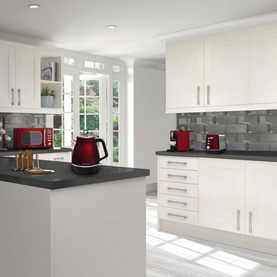 Morphy Richards Evoke Jug Kettle 1.5L in red, styled in a modern white kitchen alongside matching red toaster and microwave