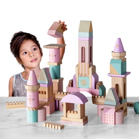 Child building a large FAO Schwarz Solid Wood Castle Blocks 75 Pieces set in cream, pink, mint and lilac pastel tones
