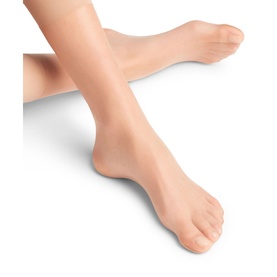Model wearing Falke Shelina Anklet Socks in Powder, ultra-sheer tan anklets with non-reinforced toes, shown on bare feet and ankles