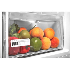 Hotpoint Larder Fridge silver interior salad drawer filled with fresh peaches, peppers, and green vegetables