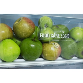 Hotpoint Larder Fridge Food Care Zone drawer filled with fresh green and red apples, showcasing dedicated fruit storage compartment