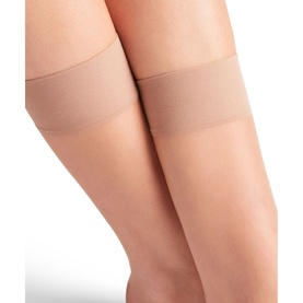 Model wearing Falke Shelina Anklet Socks in Brazil brown, ultra-sheer finish with a wide sensitive comfort cuff band